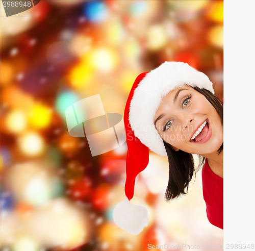 Image of woman in santa helper hat with blank white board