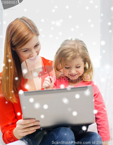 Image of happy mother and daughter with laptop computer