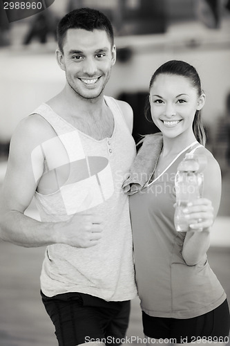 Image of two smiling people in the gym