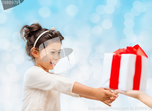 Image of smiling little girl with gift box