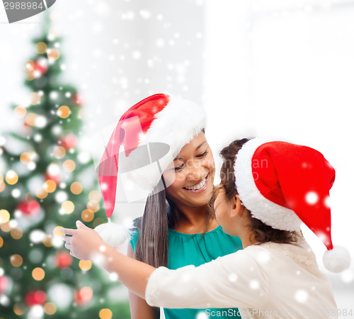 Image of happy mother and child girl with gift box