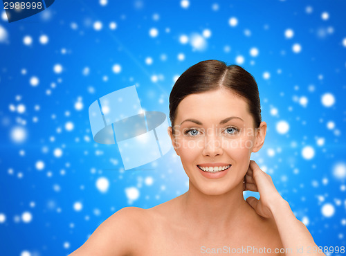 Image of smiling young woman with bare shoulders