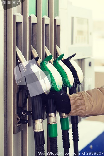 Image of close up of male hand holding fuel pump