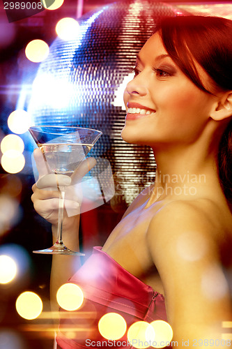 Image of woman with cocktail and disco ball