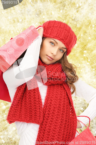 Image of smiling young woman with shopping bags