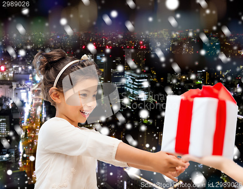 Image of smiling little girl with gift box