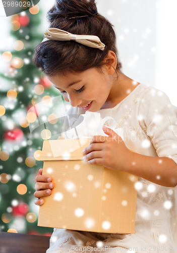 Image of smiling little girl with gift box