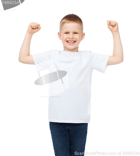 Image of little boy in blank white t-shirt showing muscles