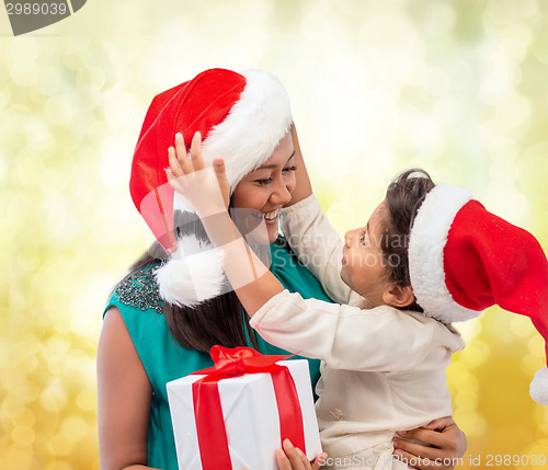 Image of happy mother and child girl with gift box