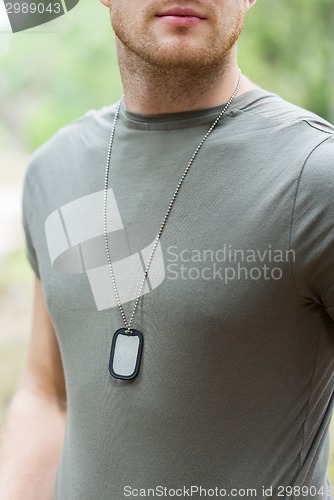 Image of close up of young soldier in military uniform