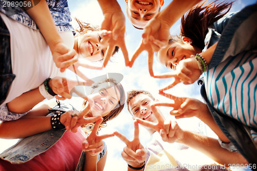 Image of group of teenagers showing finger five