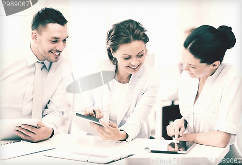 Image of business team working with tablet pcs in office