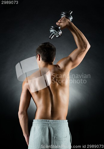 Image of young man with dumbbell