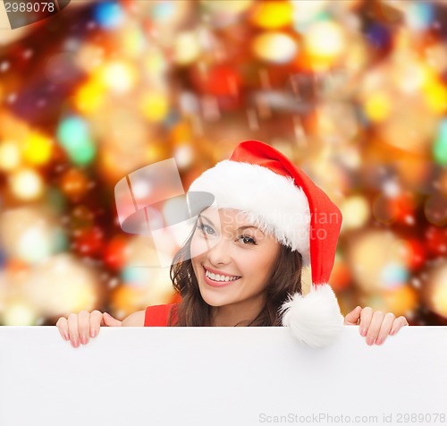 Image of woman in santa helper hat with blank white board