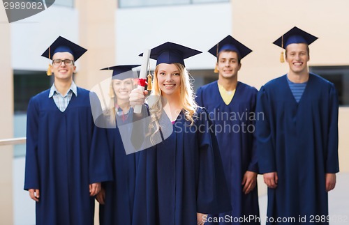 Image of group of smiling students in mortarboards