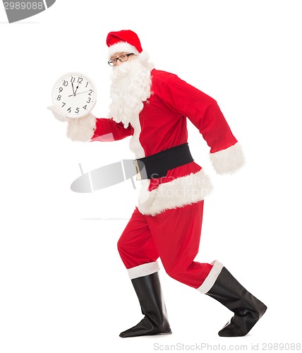 Image of man in costume of santa claus with clock