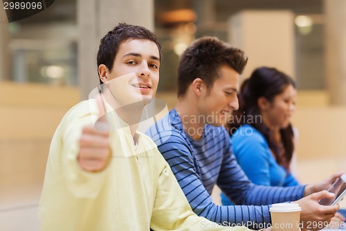 Image of group of students with tablet pc and coffee cup