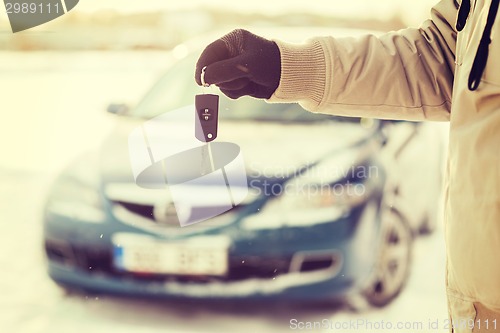 Image of closeup of man hand with car key outdoors