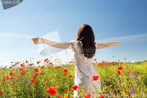 Image of young woman on poppy field