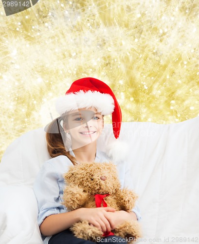 Image of smiling little girl with teddy bear