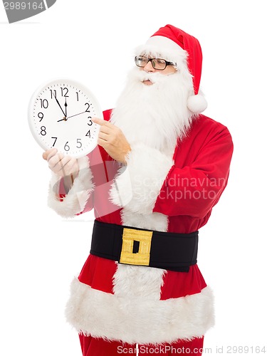 Image of man in costume of santa claus with clock