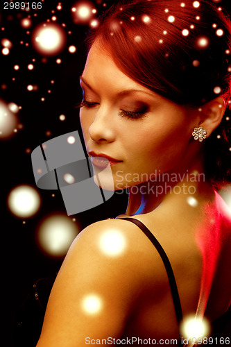 Image of woman in evening dress wearing diamond earrings