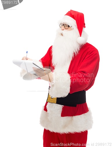 Image of man in costume of santa claus with notepad