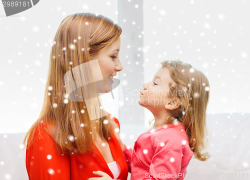 Image of happy mother and daughter kissing