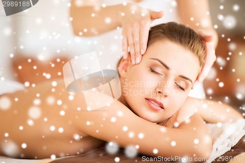 Image of beautiful woman getting face or head massage