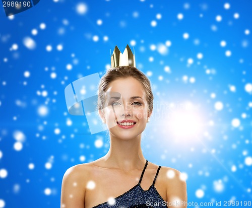 Image of smiling woman in evening dress wearing crown
