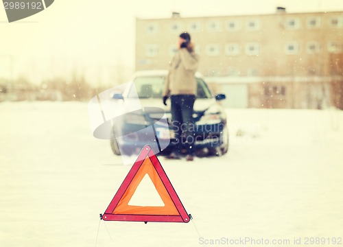 Image of closeup of man with broken car and smartphone