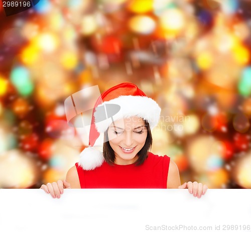 Image of woman in santa helper hat with blank white board