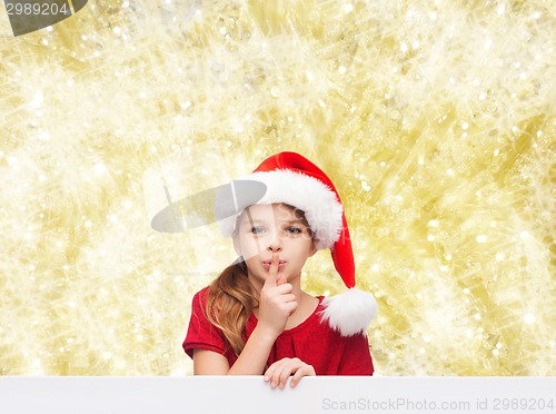 Image of smiling little girl in santa helper hat