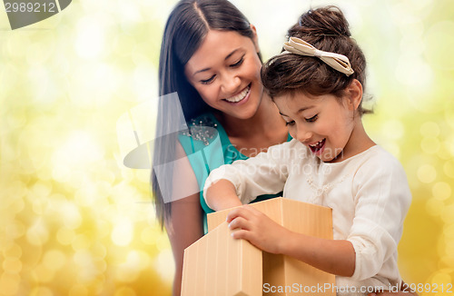 Image of happy mother and child girl with gift box