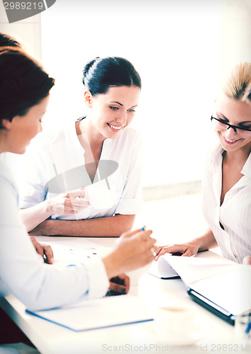 Image of businesswoman with team on meeting in office