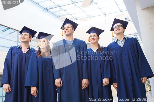 Image of group of smiling students in mortarboards