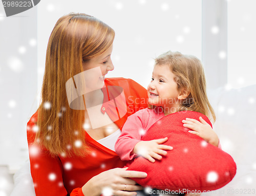 Image of mother and daughter with heart shape pillow