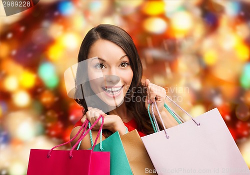 Image of smiling woman with colorful shopping bags