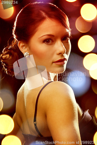 Image of woman in evening dress wearing diamond earrings