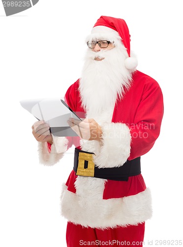 Image of man in costume of santa claus with notepad