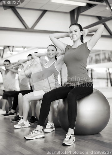 Image of group of people working out in pilates class