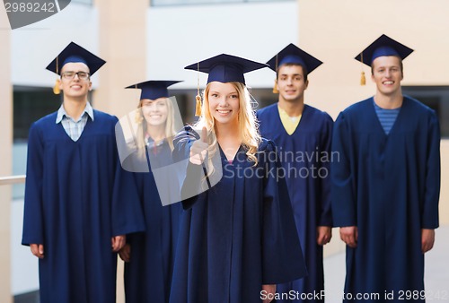 Image of group of smiling students in mortarboards