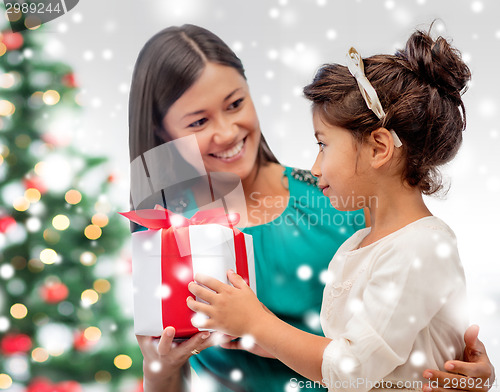 Image of happy mother and child girl with gift box