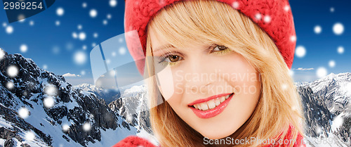 Image of close up of smiling young woman in winter clothes