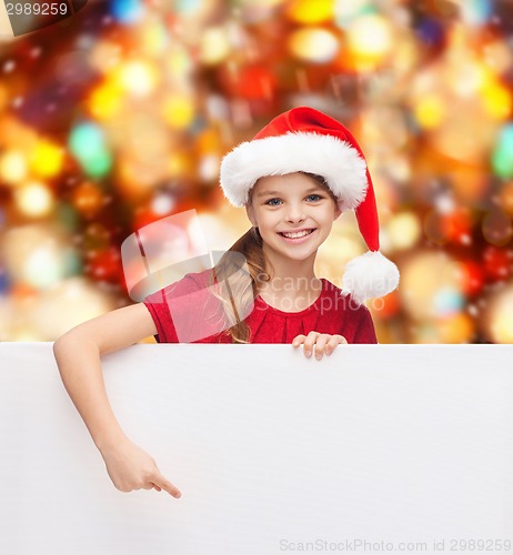 Image of girl in santa helper hat with blank white board