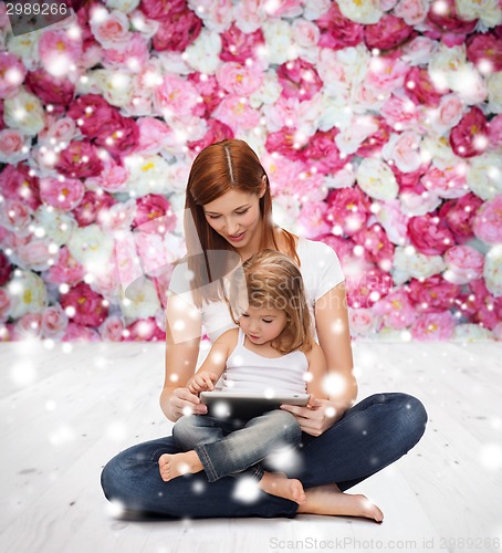 Image of happy mother with little girl and tablet pc