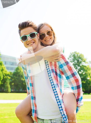 Image of smiling couple having fun in park