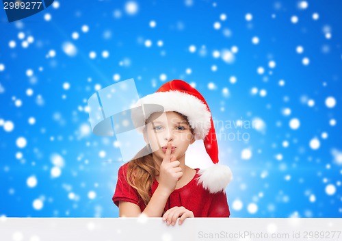 Image of smiling little girl in santa helper hat