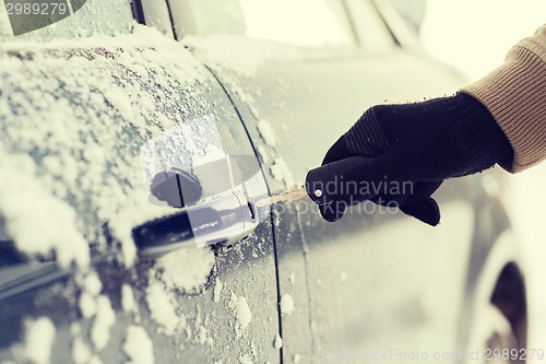 Image of closeup of man hand opening car with key