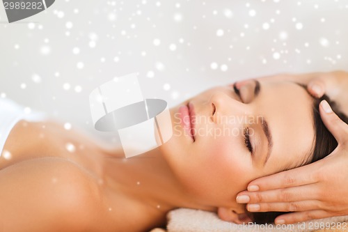 Image of beautiful woman getting face or head massage